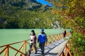 Tourists walking along the catwalks of Caleta Tortel Guide of , 